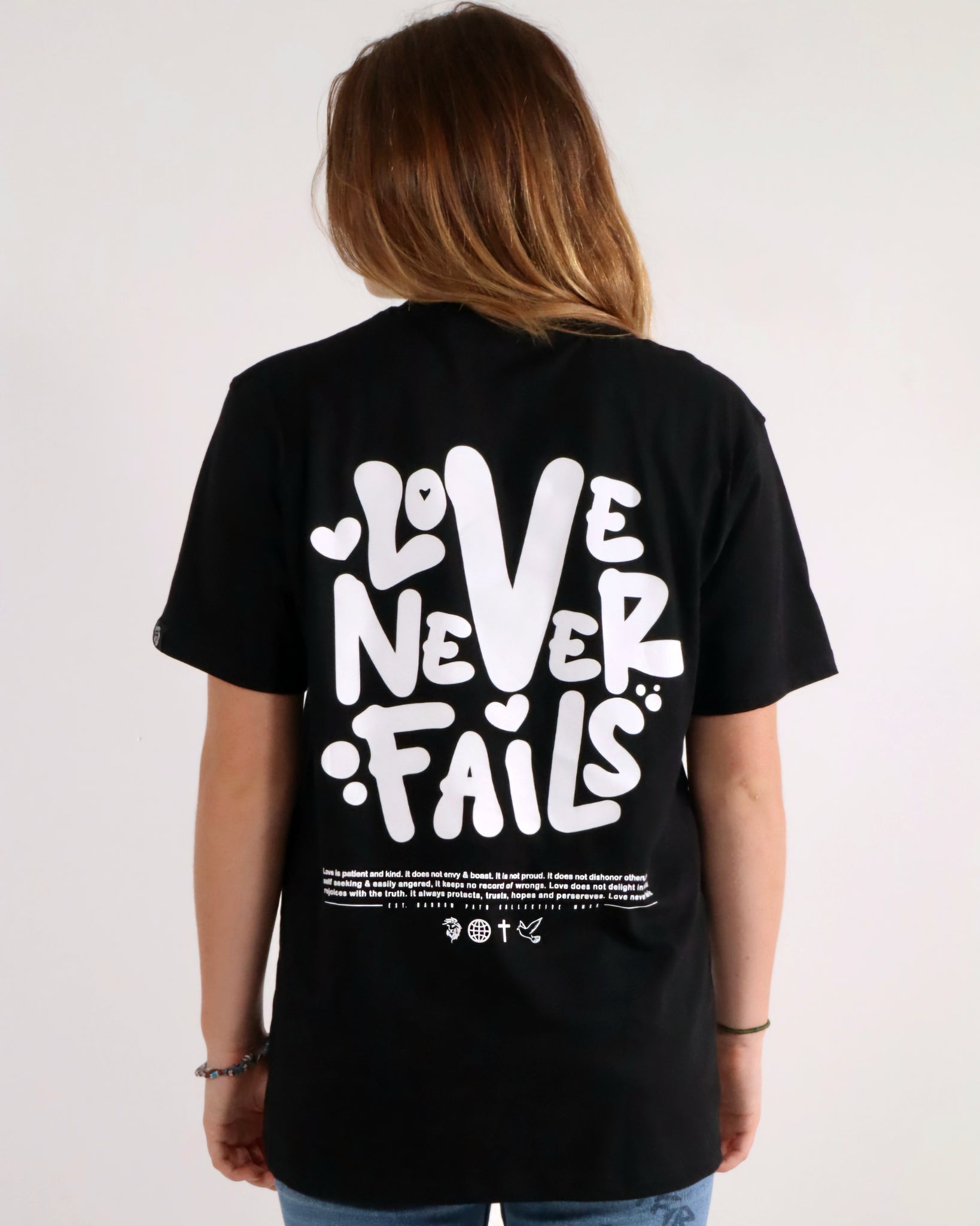 LOVE NEVER FAILS TEE BLACK