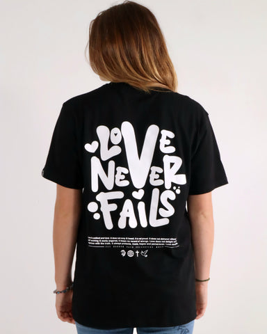 LOVE NEVER FAILS TEE BLACK