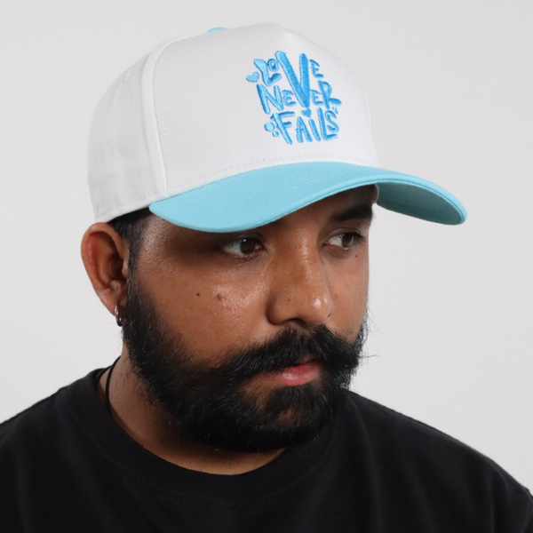 LOVE NEVER FAILS EMBROIDERED SNAPBACK HAT