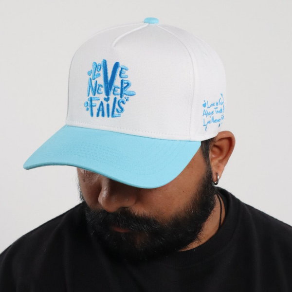 LOVE NEVER FAILS EMBROIDERED SNAPBACK HAT