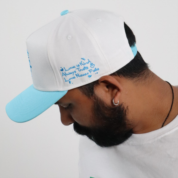LOVE NEVER FAILS EMBROIDERED SNAPBACK HAT