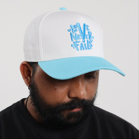 LOVE NEVER FAILS EMBROIDERED SNAPBACK HAT
